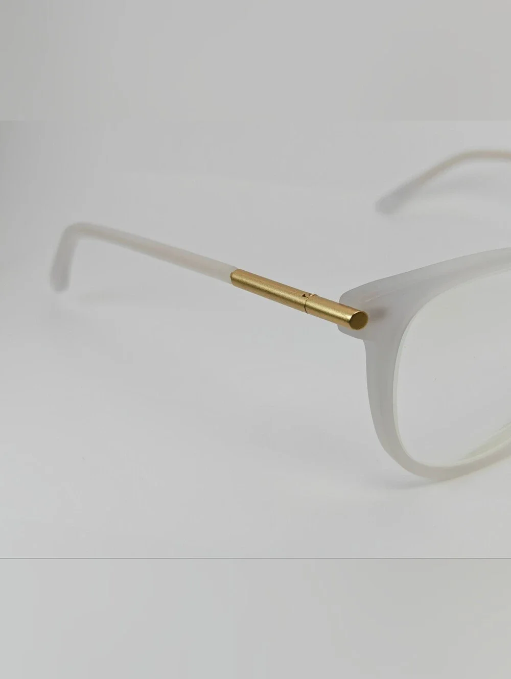 Cylinder. Women's Frosted White Round Frame Glasses. Cylinder Gold Highlights.